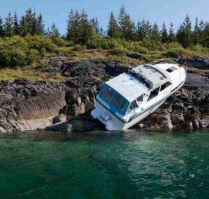 boat crashing into rocks